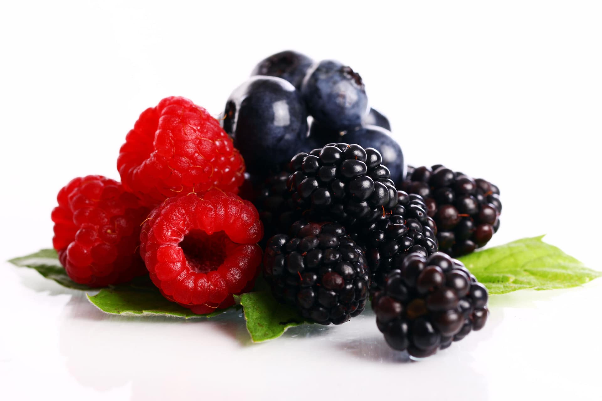 Fresh forest berries over white background